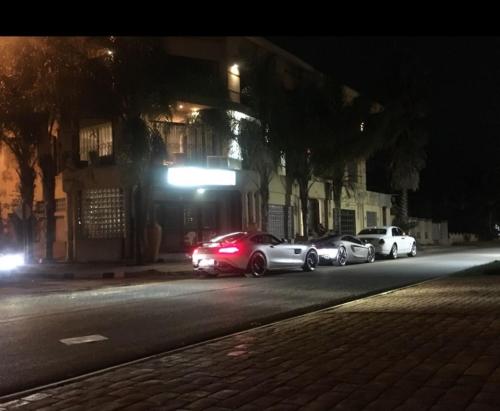 a group of cars parked on a street at night at Lenasia Guest Lodge in Lenasia