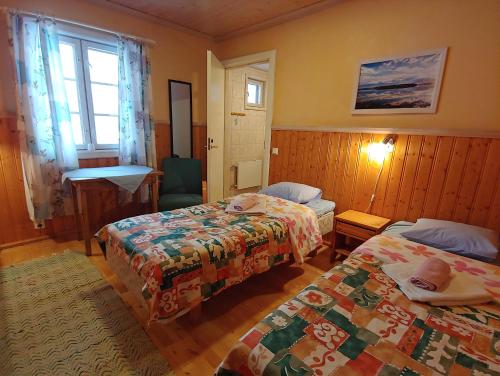 a hotel room with two beds and a window at Herranniemi Guesthouse in Vuonislahti