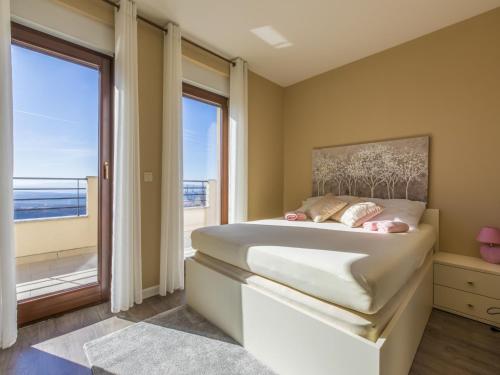 a bedroom with a bed with a view of the ocean at Apartment PEZ in Hreljin