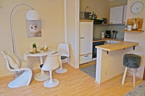 małą kuchnię ze stołem i krzesłami w pokoju w obiekcie Appartment Indira w mieście Bad Sobernheim