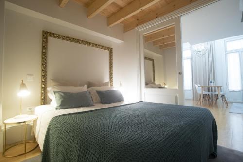 a bedroom with a bed with a large mirror on the wall at Mercado dos Poetas – Tourism Apartments in Porto