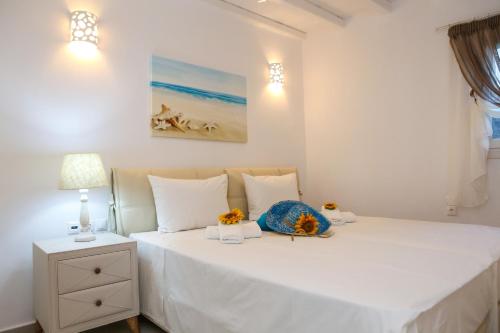 Ένα ή περισσότερα κρεβάτια σε δωμάτιο στο Venus Myconian Residences