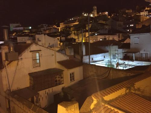 a view of a city at night at Pequeno Hostel Studio in Lisbon