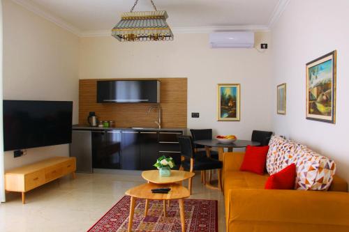a living room with a couch and a table at sul mare סוויטות in Ashqelon