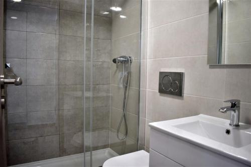 een badkamer met een douche, een toilet en een wastafel bij Rua José Afonso in Albufeira