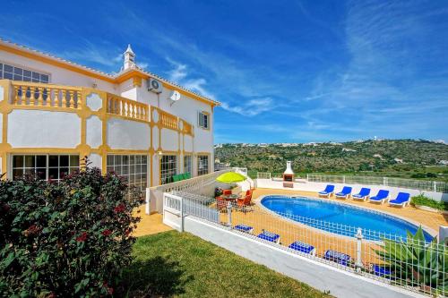 a villa with a swimming pool in a yard at Villa Sunny in Albufeira
