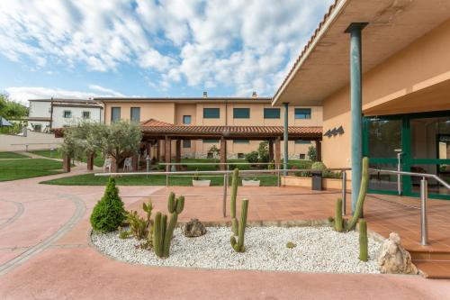 a cactus garden in front of a building at Casa Santa Elena in Santa Cristina d'Aro