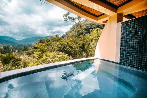 a swimming pool with a view of the mountains at Sleeping Giant Rainforest Lodge in Belmopan