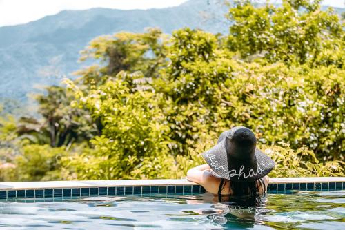 a bird in the water in a swimming pool at Sleeping Giant Rainforest Lodge in Belmopan