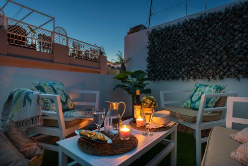 a patio with a table with candles and chairs at Genteel Home Galera in Seville