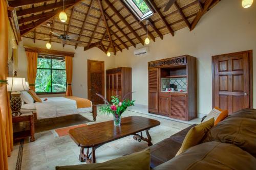 a living room with a couch and a table at Sleeping Giant Rainforest Lodge in Belmopan