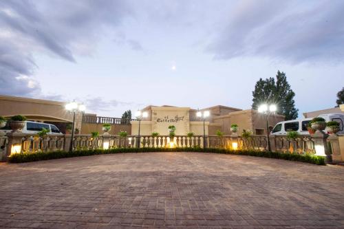 a driveway in front of a building with a fence at IL Castello in Clarens