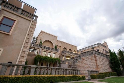 a large building with a fence in front of it at IL Castello in Clarens