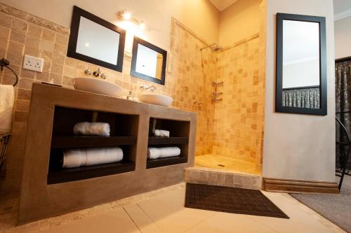 a bathroom with two sinks and a shower at IL Castello in Clarens