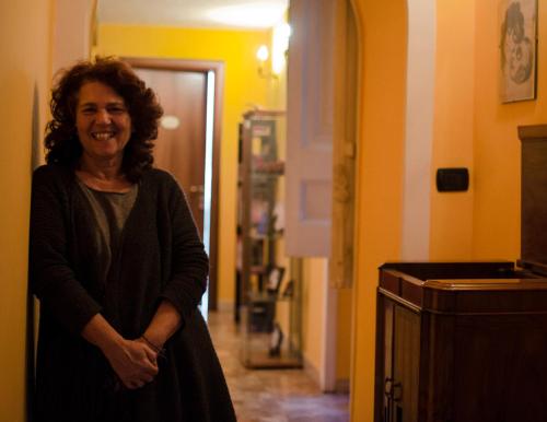 a woman is standing in a hallway at A Casa di Mamma in Naples