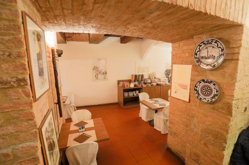 a room with a table and chairs and a counter at Hotel Duomo in Siena