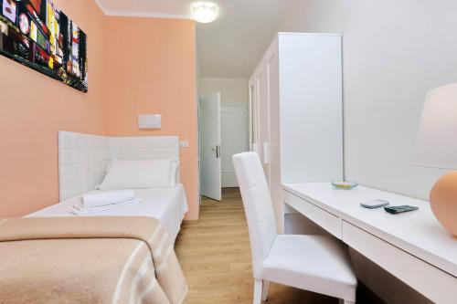 a small room with a bed and a desk at Antico Platano in Rome