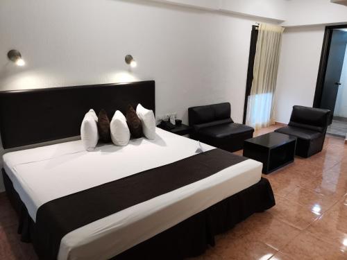 Ένα ή περισσότερα κρεβάτια σε δωμάτιο στο Hotel Maya Yucatan