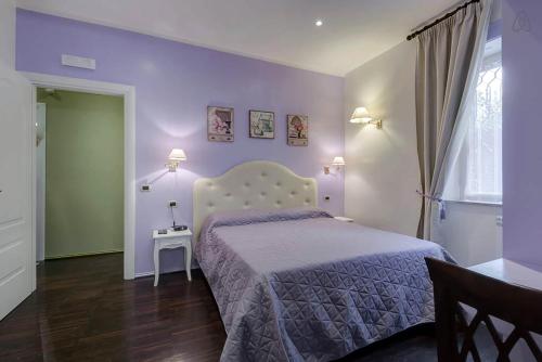 a bedroom with a bed with purple walls at Antico Platano in Rome