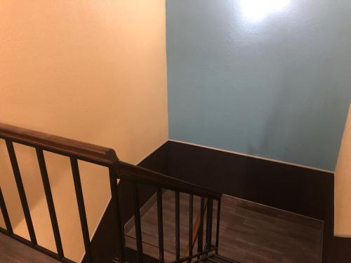 a staircase with a blue wall and a stair case at Days Inn by Wyndham Grove City Columbus South in Grove City