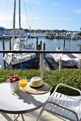 a table with a hat and a glass of orange juice at Cove Inn on Naples Bay in Naples