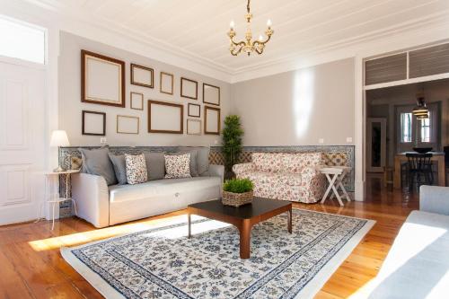a living room with a couch and a table at Camoes by Central Hill Apartments in Lisbon