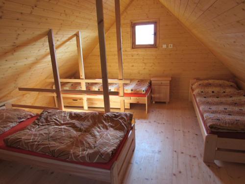 a attic room with two beds and a loft at Rybářská Chata U Sumce in Stříbro