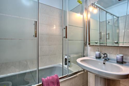 a bathroom with a sink and a shower at Garden Cristo Rei in Lisbon