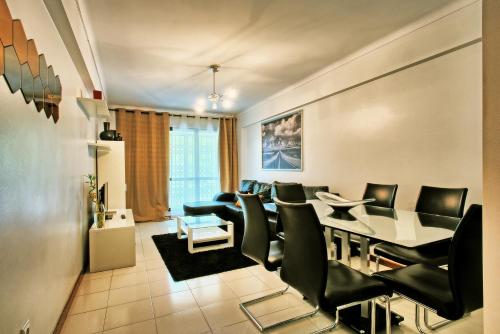 a living room with a dining room table and chairs at Garden Cristo Rei in Lisbon