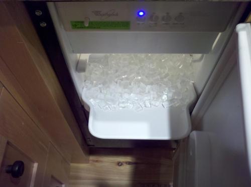 an open refrigerator with ice inside of it at Penthouse By The Gondola in Telluride