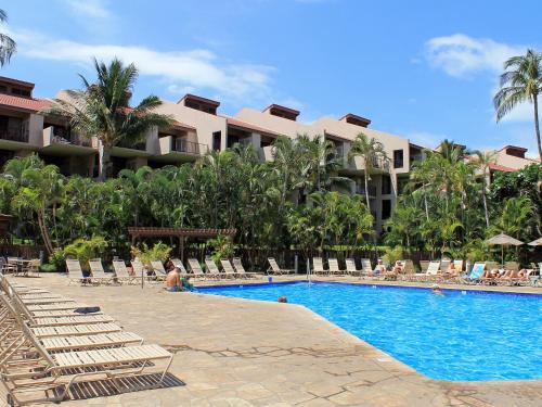 a resort with a swimming pool with lounge chairs at Castle Kama'ole Sands in Wailea
