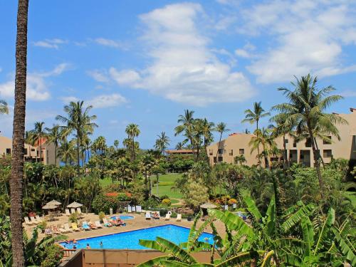 a view of a resort with a pool and palm trees at Castle Kama'ole Sands in Wailea