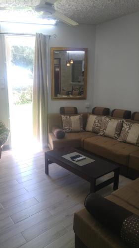 a living room with a couch and a coffee table at Beach Apartment in Pereybere