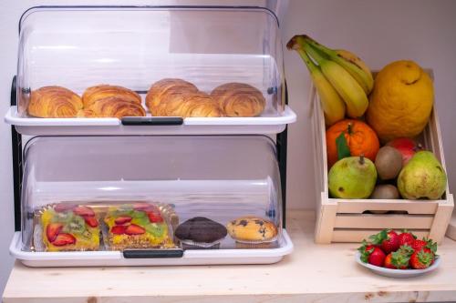 an open refrigerator with food and fruit on a table at ALBA DEL CAPO in Palermo