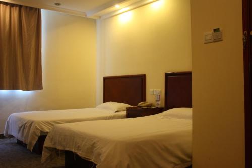a hotel room with two beds and a window at GMA Hotel ShangHai WuNing Road ZhenPing Road Metro Station in Shanghai