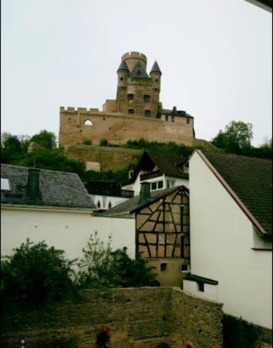 a castle on top of a hill with buildings at Gästehaus "Auszeit" in Burgschwalbach