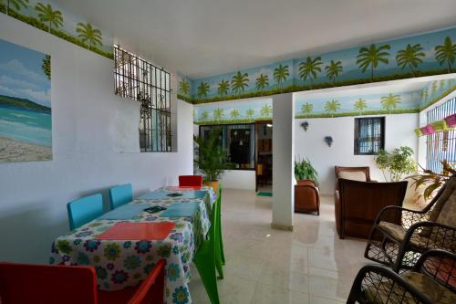 a dining room with two tables and a living room at Villa Alégria in Santa Bárbara de Samaná