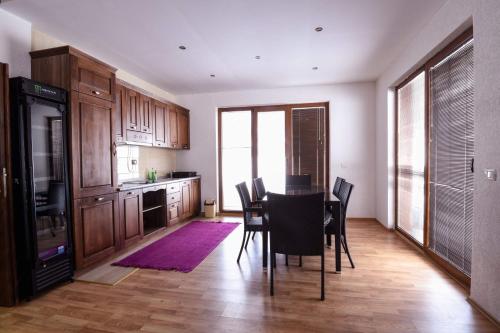 a kitchen with a dining room table and chairs at Villa 'Iva' in Mavrovo