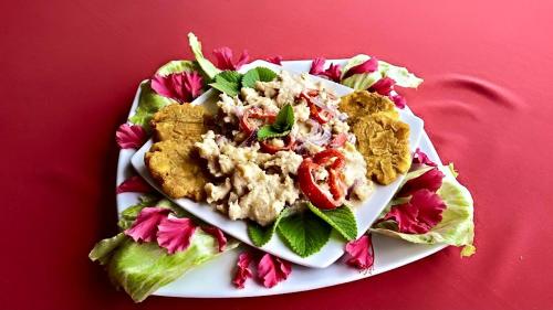 a plate of food on a red table at Cabañas y Restaurante Miss Elma in Providencia