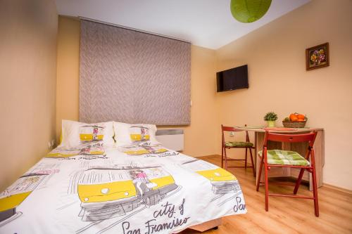 a bedroom with a bed with a drawing of a bus at Green Orange Apartment in Bansko
