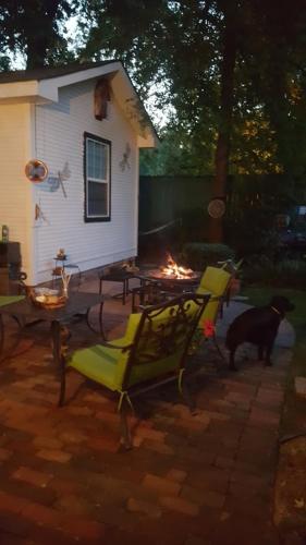 a backyard with a house and a dog and a fireplace at The Carriage House in Jefferson