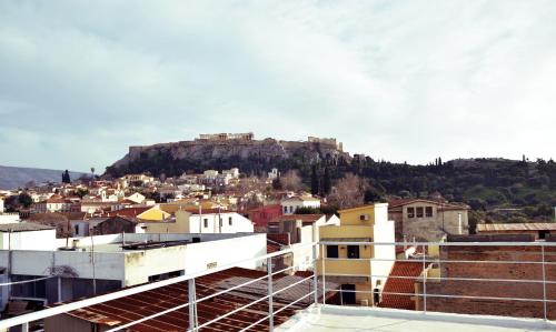 a view of a city with a mountain in the background at Apartment with Rooftop Terrace & Acropolis View in Athens