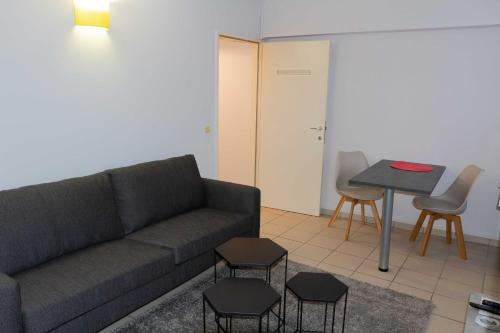 a living room with a couch and a table at Renovated Apartment in Antwerp city center in Antwerp