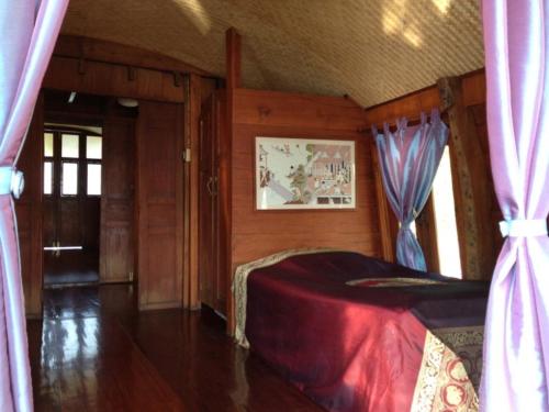 Postel nebo postele na pokoji v ubytování Ayothaya Riverside House