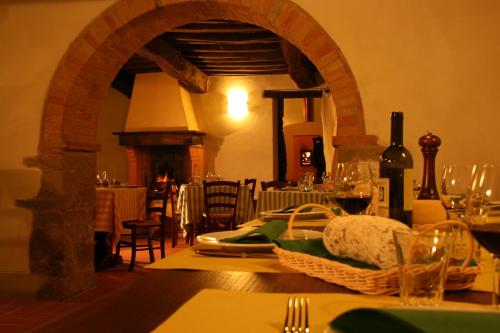 a dining room with a table with wine glasses at Locanda Del Viandante B&B in Anghiari