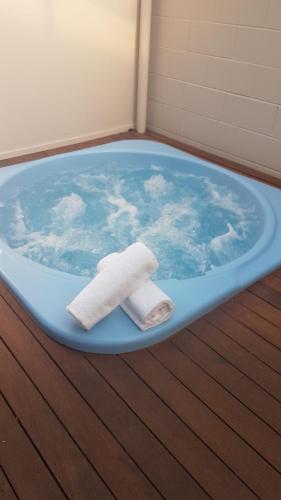 a bath tub with two towels sitting in it at Wylie Court Motor Lodge in Rotorua