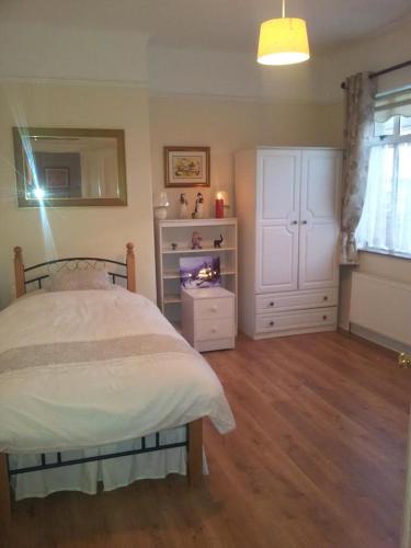 a bedroom with a bed and a fireplace in it at Town House in Ennis