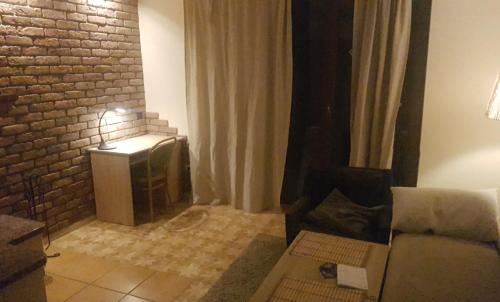 a living room with a couch and a television at Bujaków, apartamenty Zdrojowa 58a in Bujaków