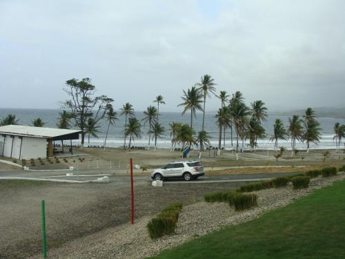 a car driving down a road next to the beach at Apartamento en BalaBeach María Chiquita in front of the beach 2hab in Colón