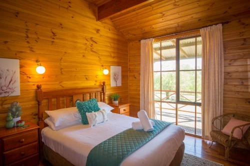 Postel nebo postele na pokoji v ubytování Silky Oak Cottage